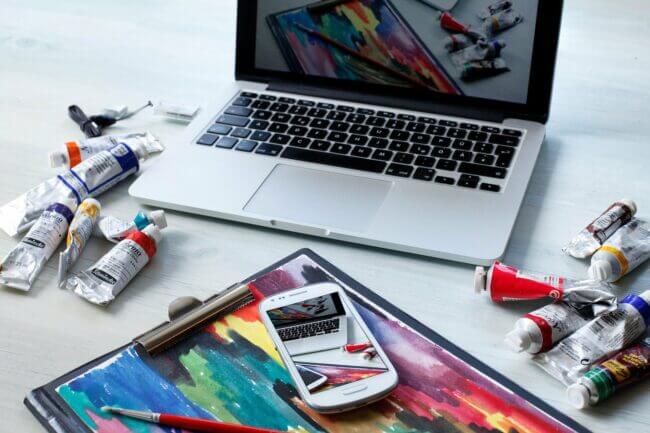 creative paint next to laptop